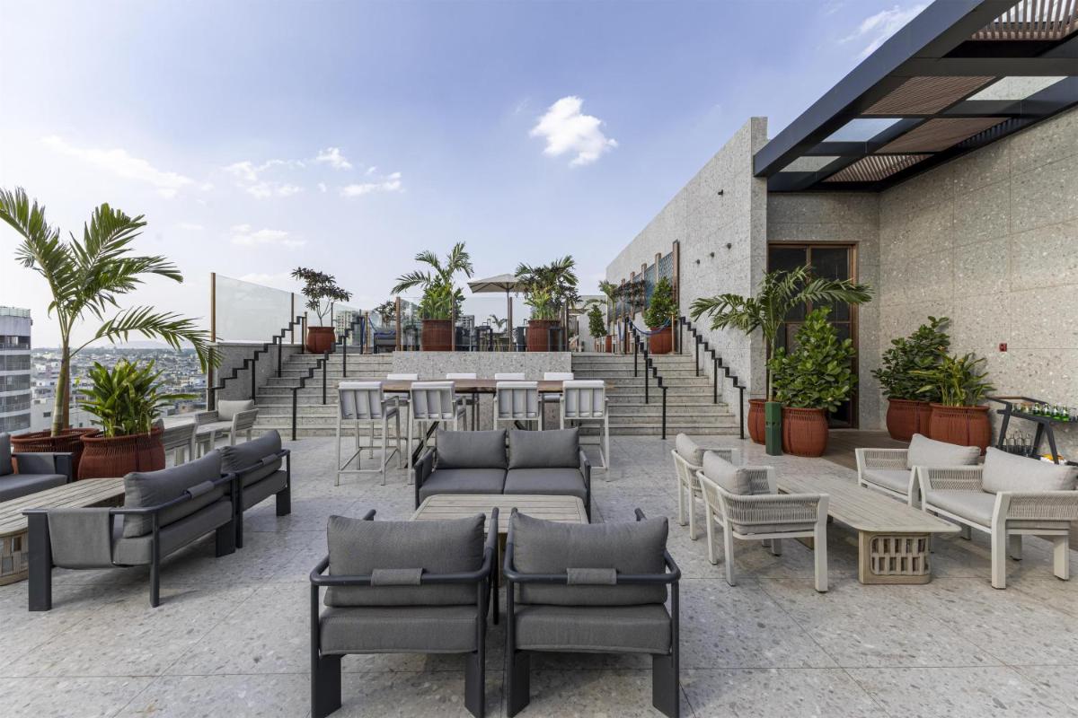 a patio with tables and chairs on a building at Radisson Blu Hotel Pune Kharadi in Pune