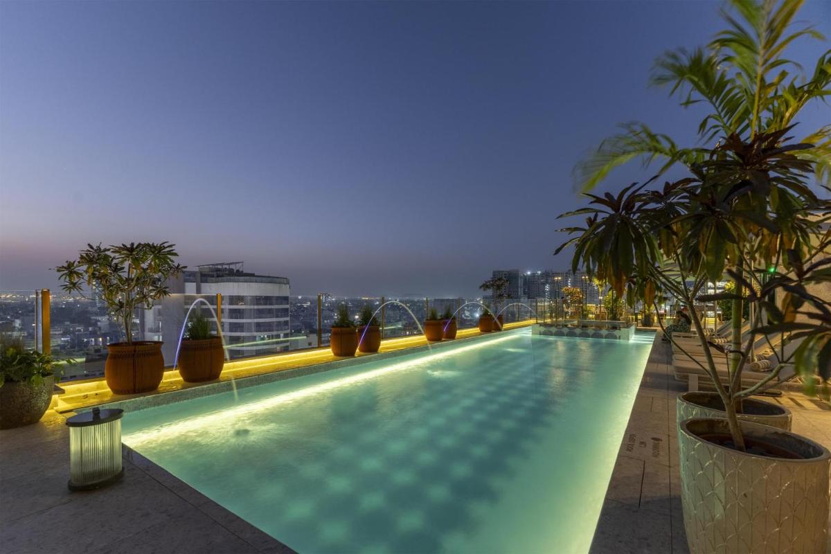 a swimming pool on the roof of a building at Radisson Blu Hotel Pune Kharadi in Pune
