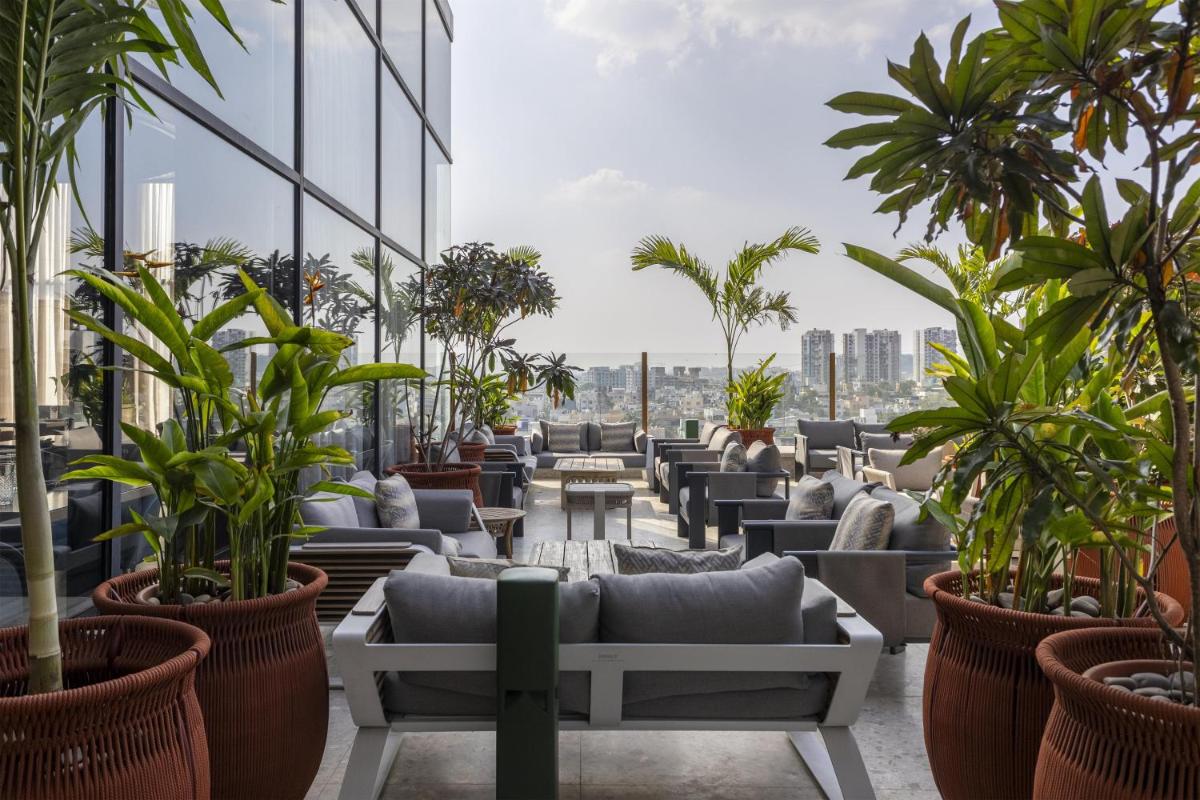 a room filled with lots of plants on a building at Radisson Blu Hotel Pune Kharadi in Pune