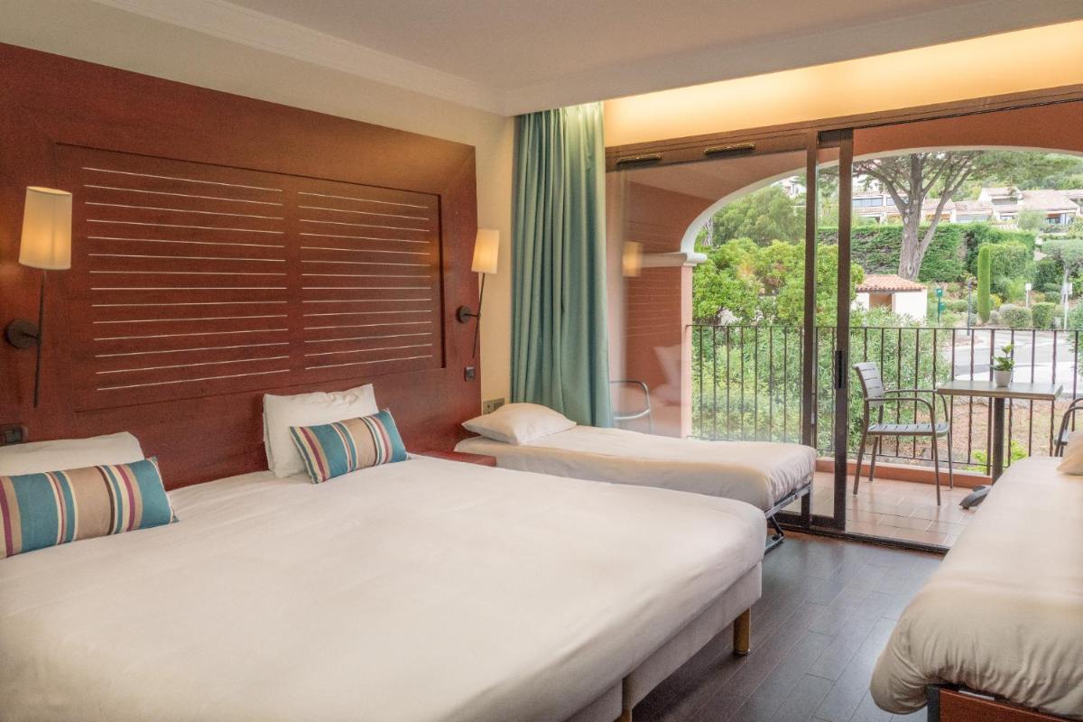 Un ou plusieurs lits dans un hébergement de l'établissement Hôtel Les Jardins De Sainte-Maxime