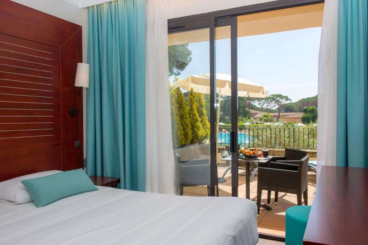 Un ou plusieurs lits dans un hébergement de l'établissement Hôtel Les Jardins De Sainte-Maxime