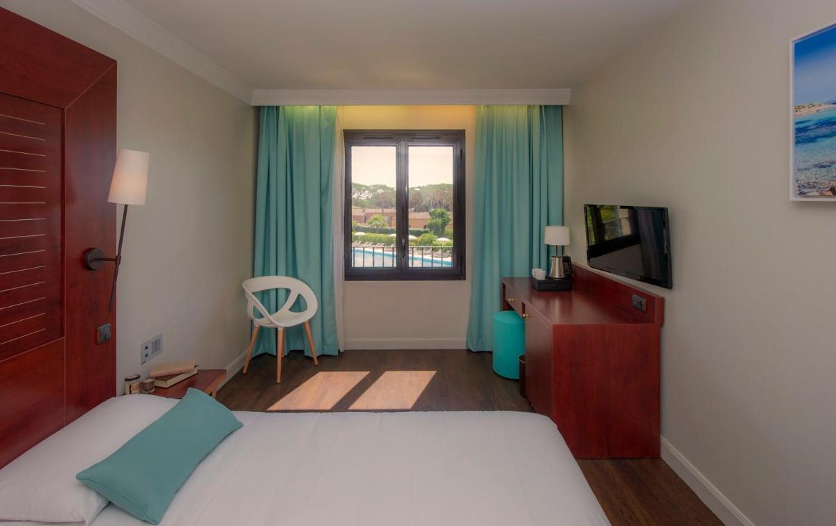 Un ou plusieurs lits dans un hébergement de l'établissement Hôtel Les Jardins De Sainte-Maxime