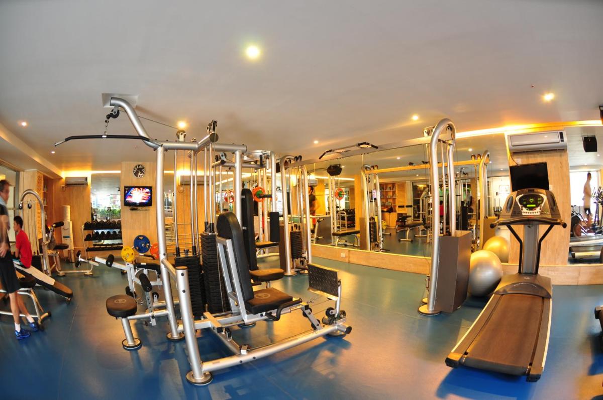 a gym with several treadmills and machines in it at Grand Mercure Bangalore - An Accor Brand in Bengaluru