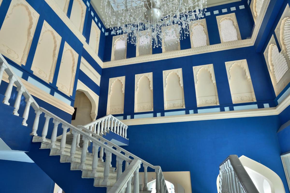 a blue and white staircase with blue walls and ceilings at Fairmont Jaipur in Jaipur