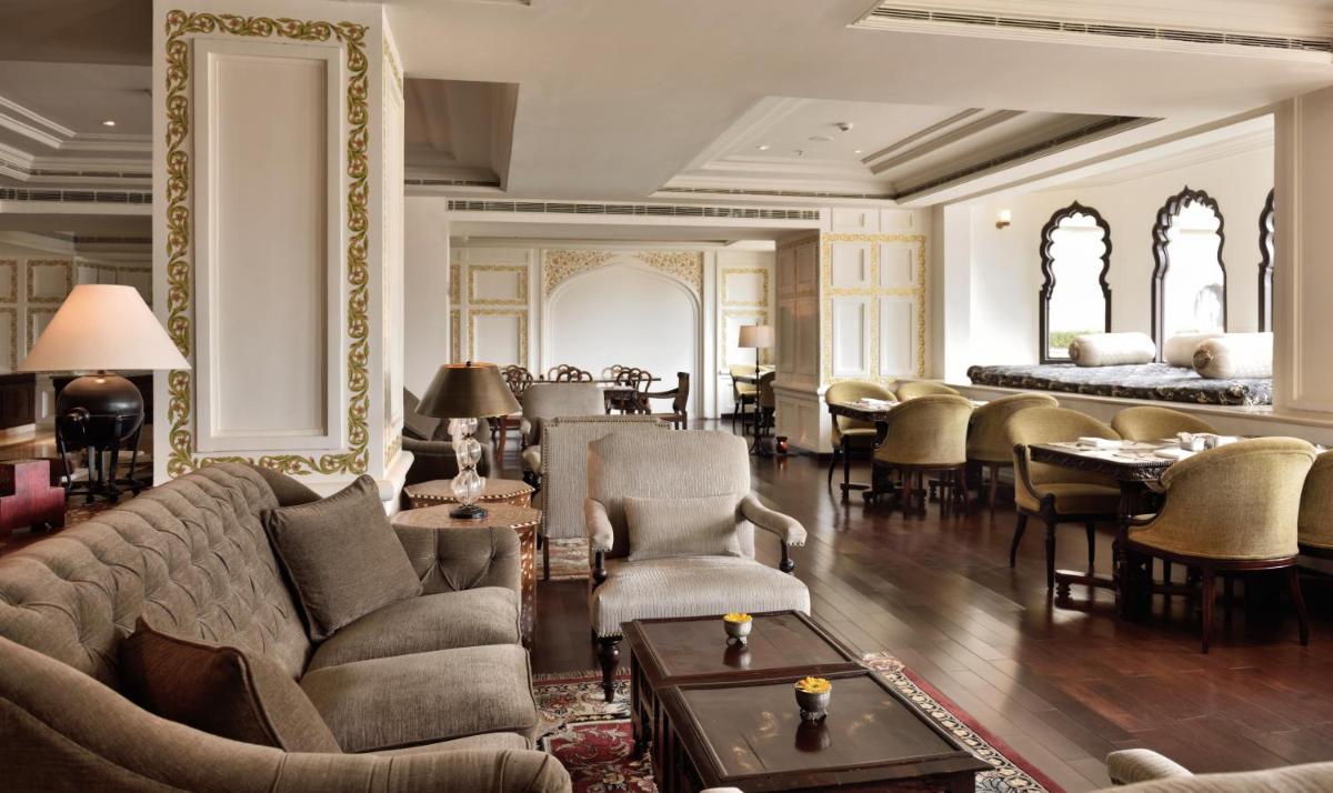 a living room with a couch and chairs and tables at Fairmont Jaipur in Jaipur