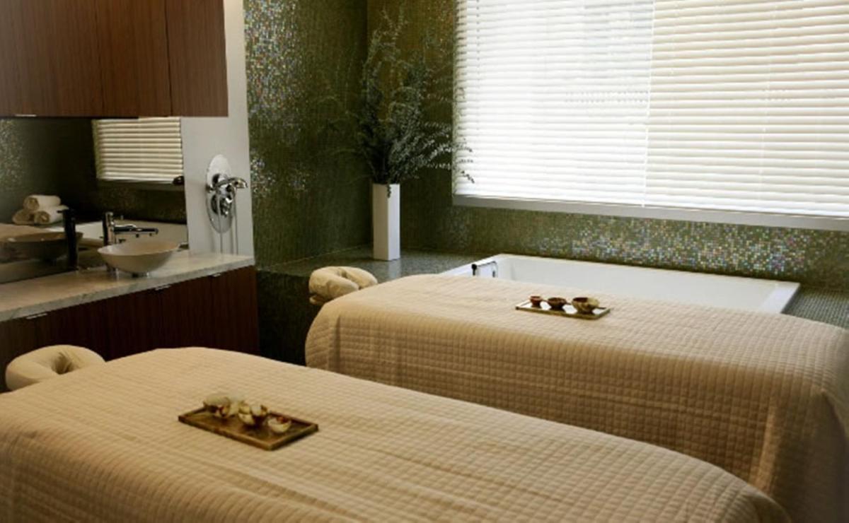 a room with two beds and a sink and a sink at The Raj Palace (Small Luxury Hotels of the World) in Jaipur