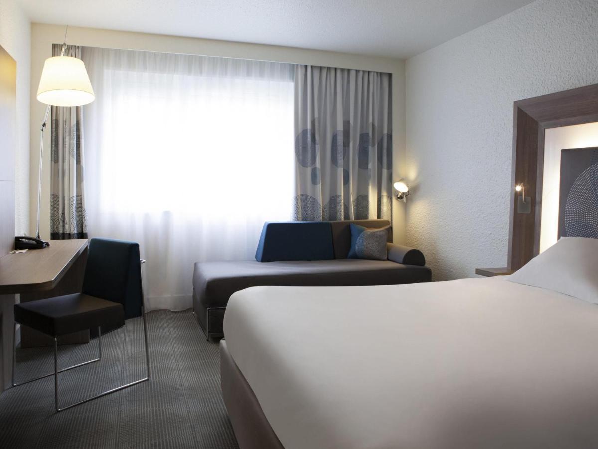 Un ou plusieurs lits dans un hébergement de l'établissement Novotel Fontainebleau Ury