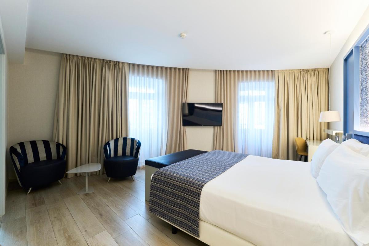 Uma cama ou camas num quarto em Catalonia Porto