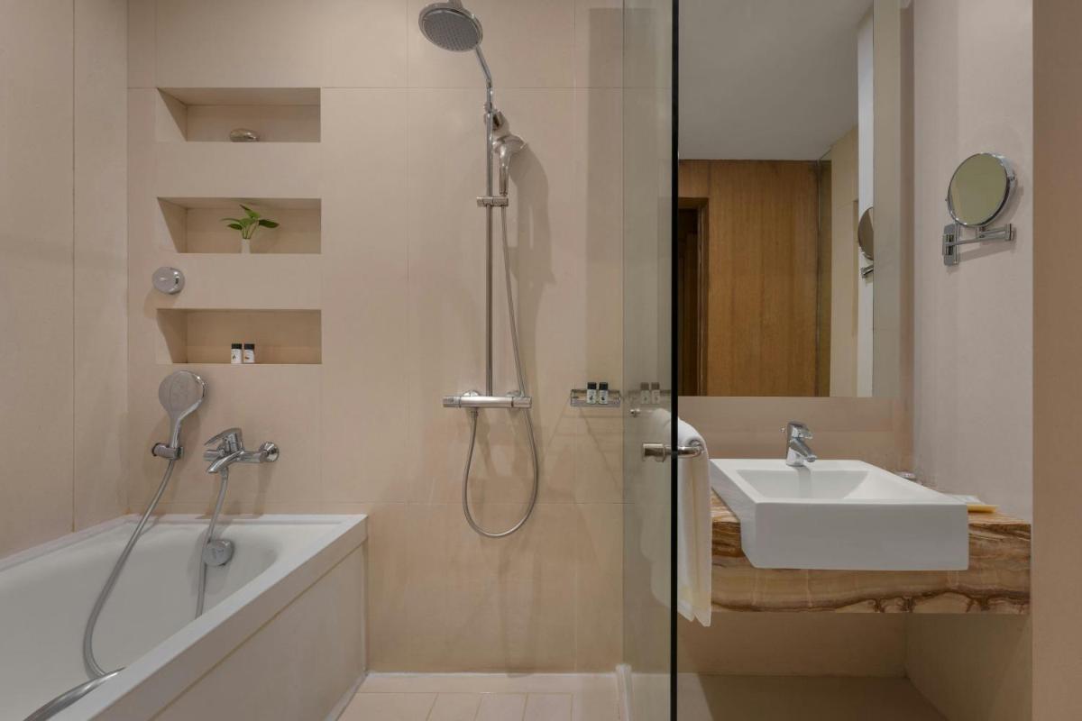 a bathroom with a shower and a sink at Meluha The Fern Mumbai, Powai, Series by Marriott in Mumbai