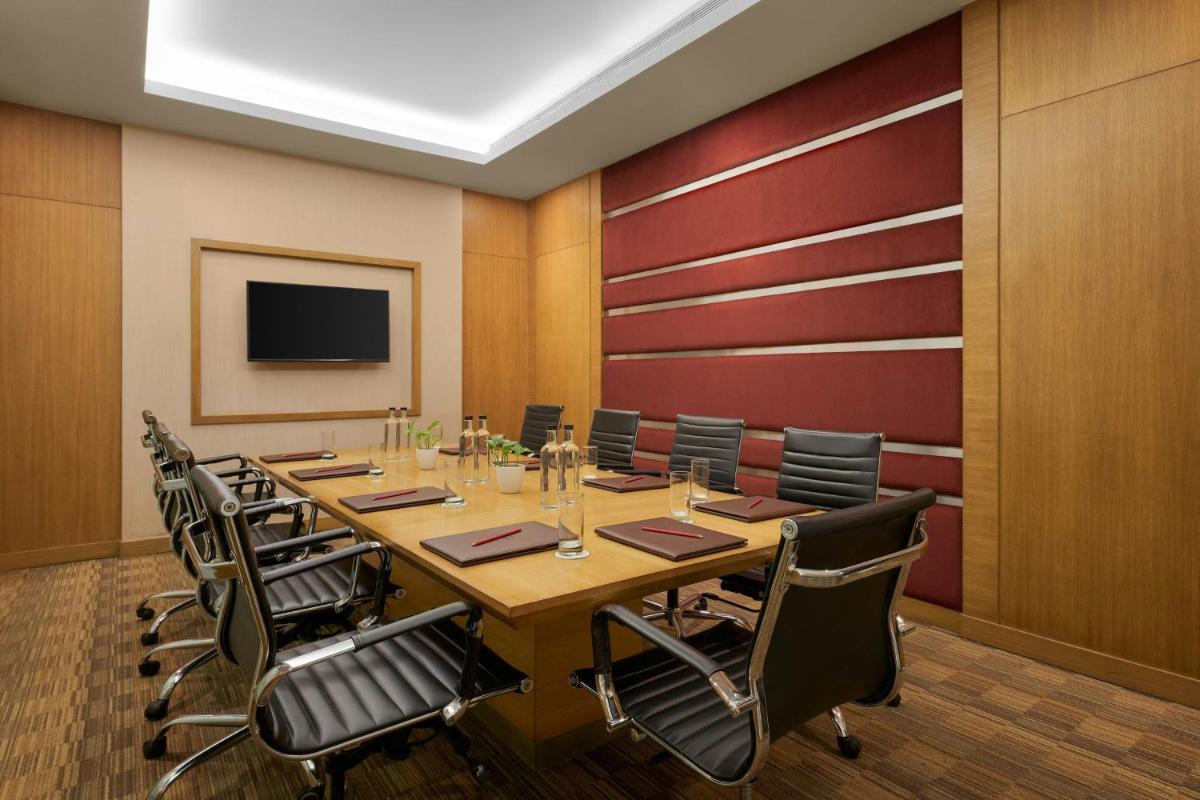a conference room with a long table and chairs at Meluha The Fern Mumbai, Powai, Series by Marriott in Mumbai