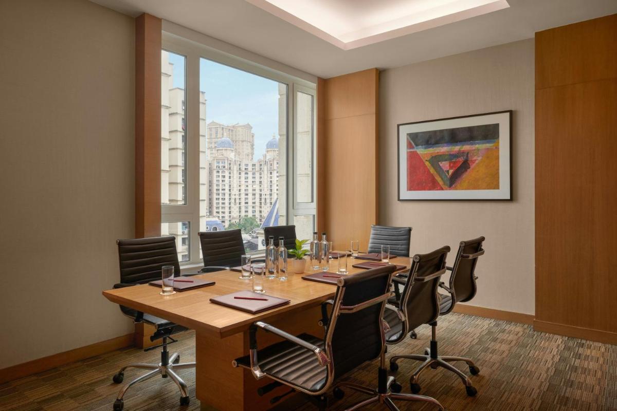 a conference room with a long table and chairs at Meluha The Fern Mumbai, Powai, Series by Marriott in Mumbai