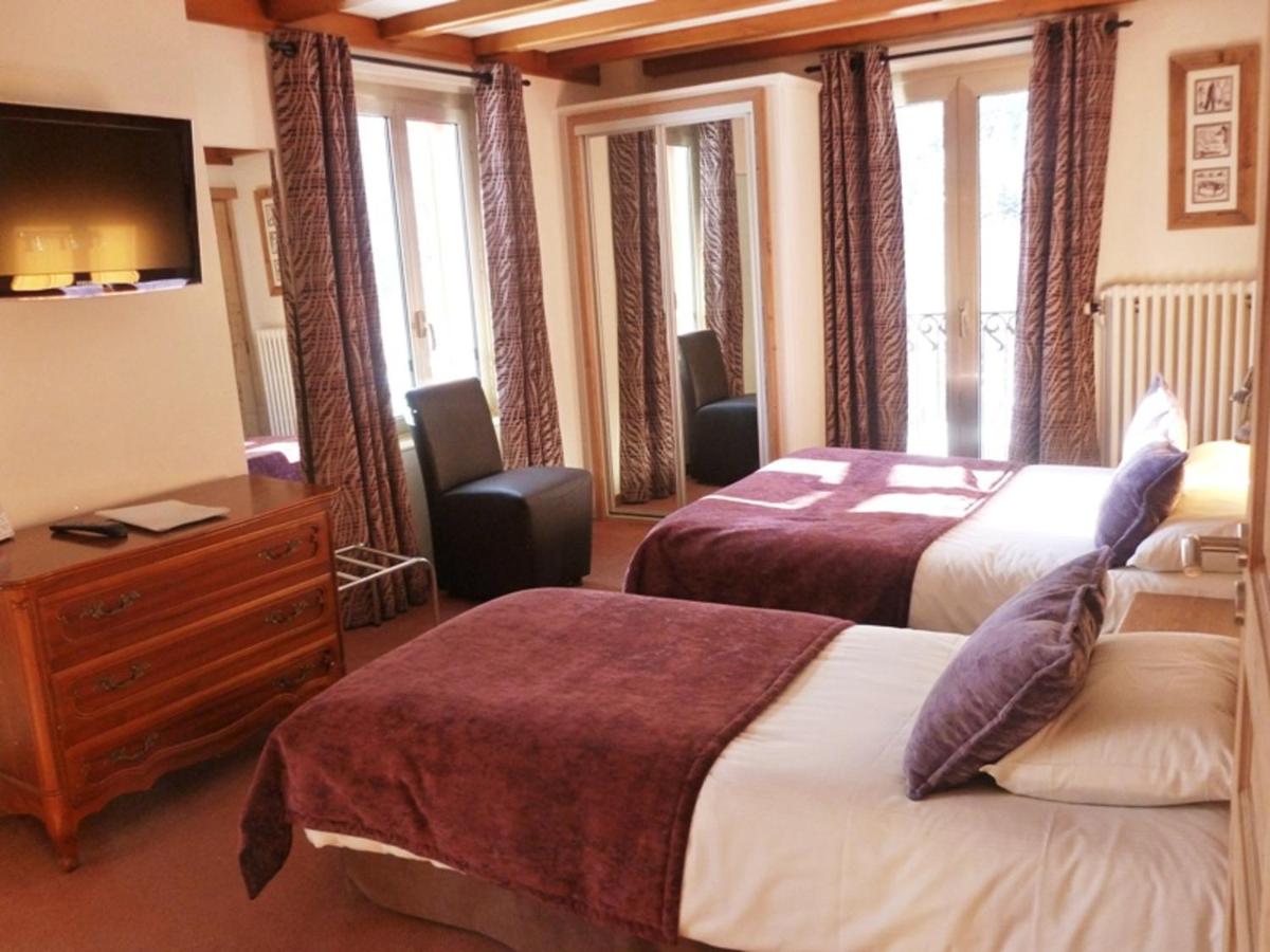 Un ou plusieurs lits dans un hébergement de l'établissement Aiguille du Midi - Hôtel & Restaurant