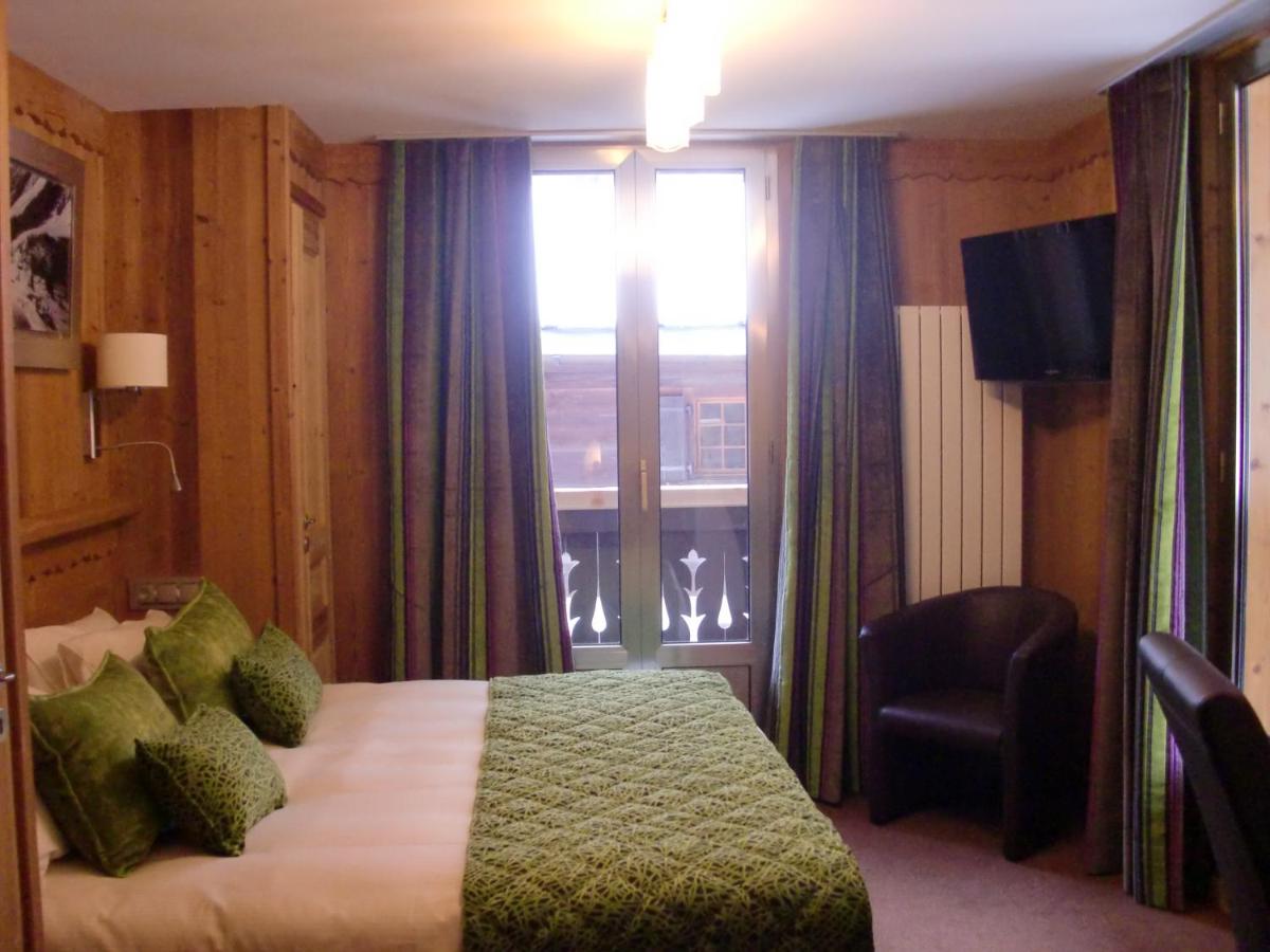 Un ou plusieurs lits dans un hébergement de l'établissement Aiguille du Midi - Hôtel & Restaurant