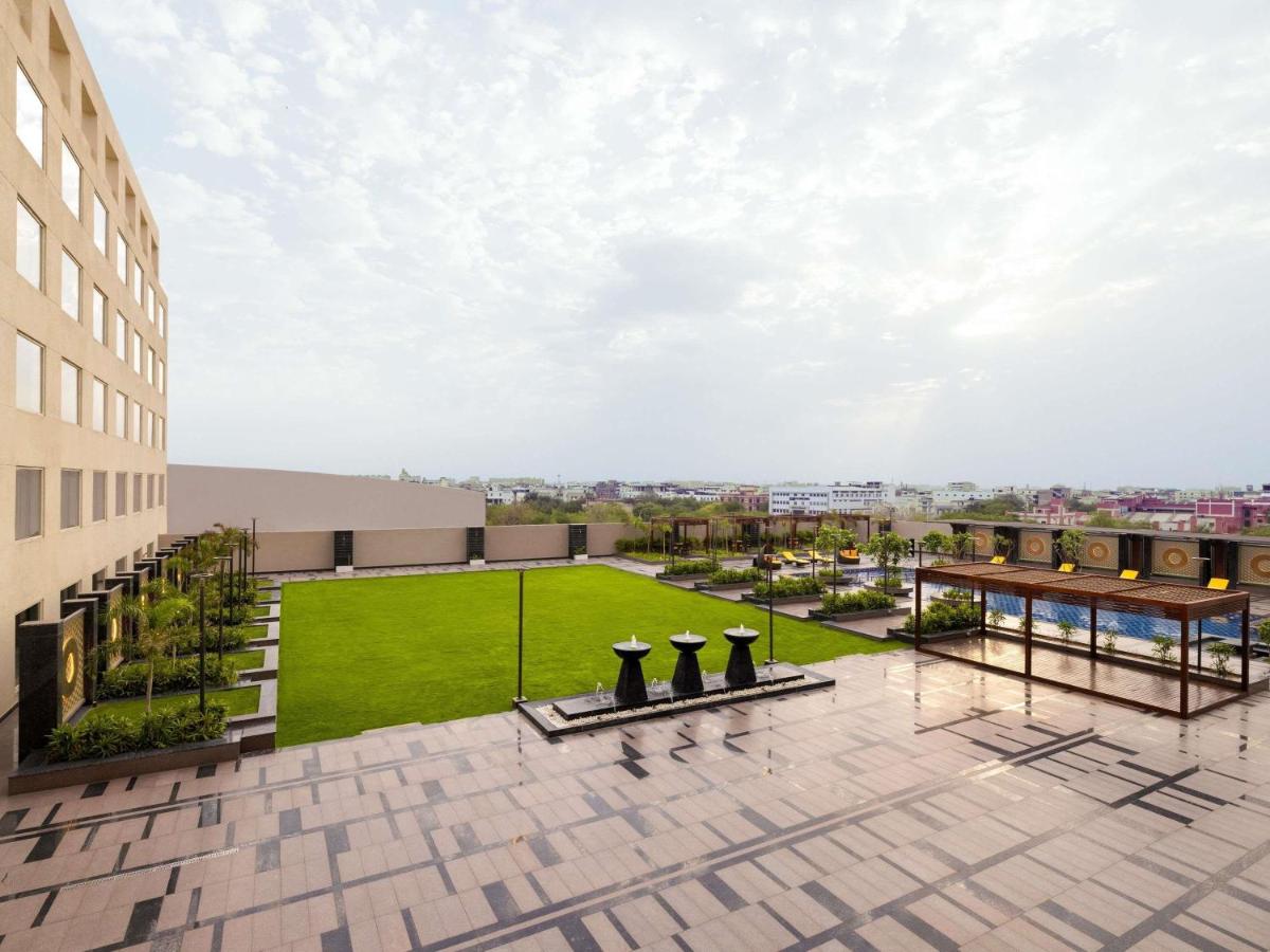 a view from the roof of a building with a lawn at Novotel Jaipur Convention Centre in Jaipur