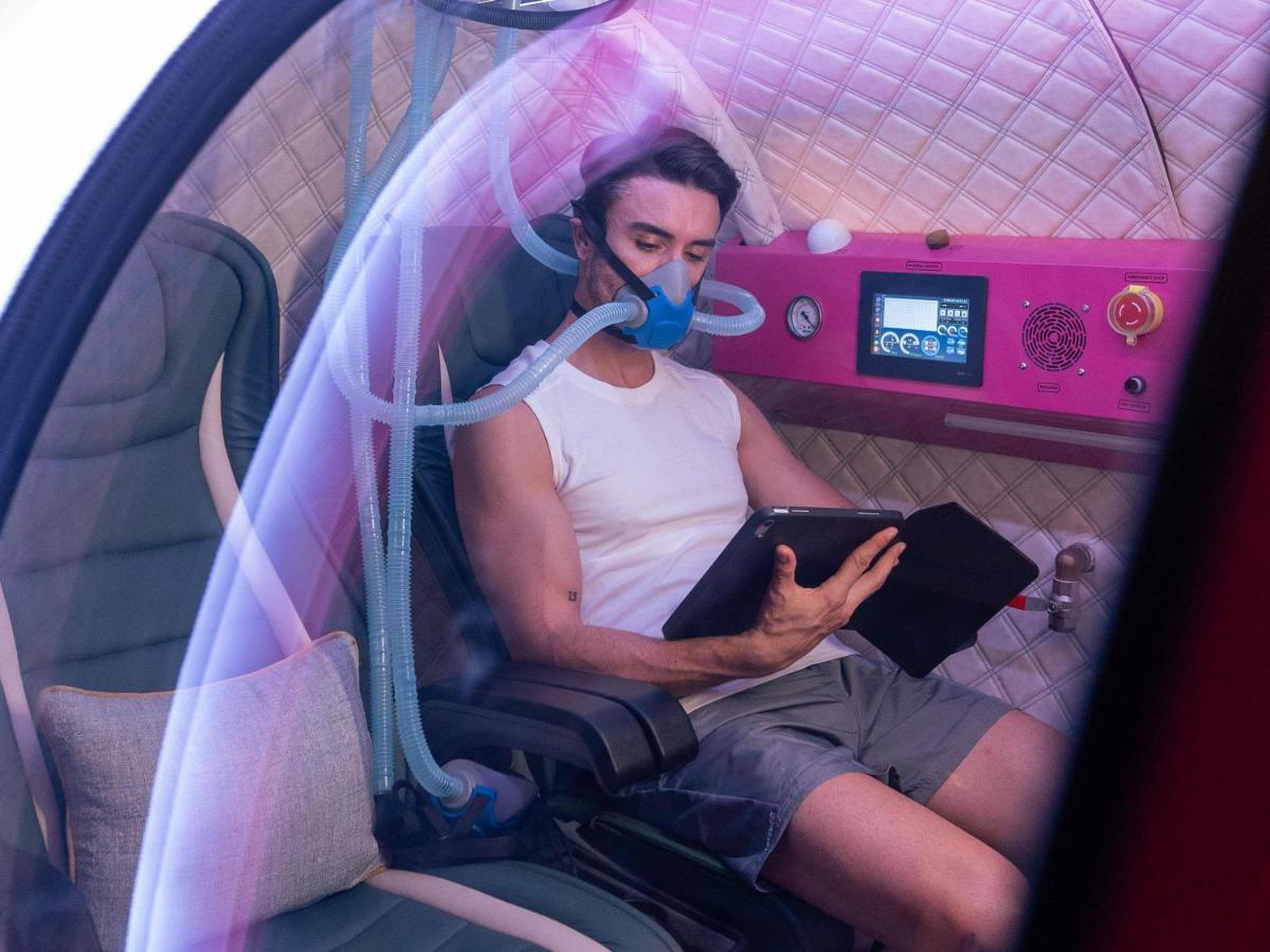 a man sitting in a tent with a face mask at Fairmont Mumbai in Mumbai