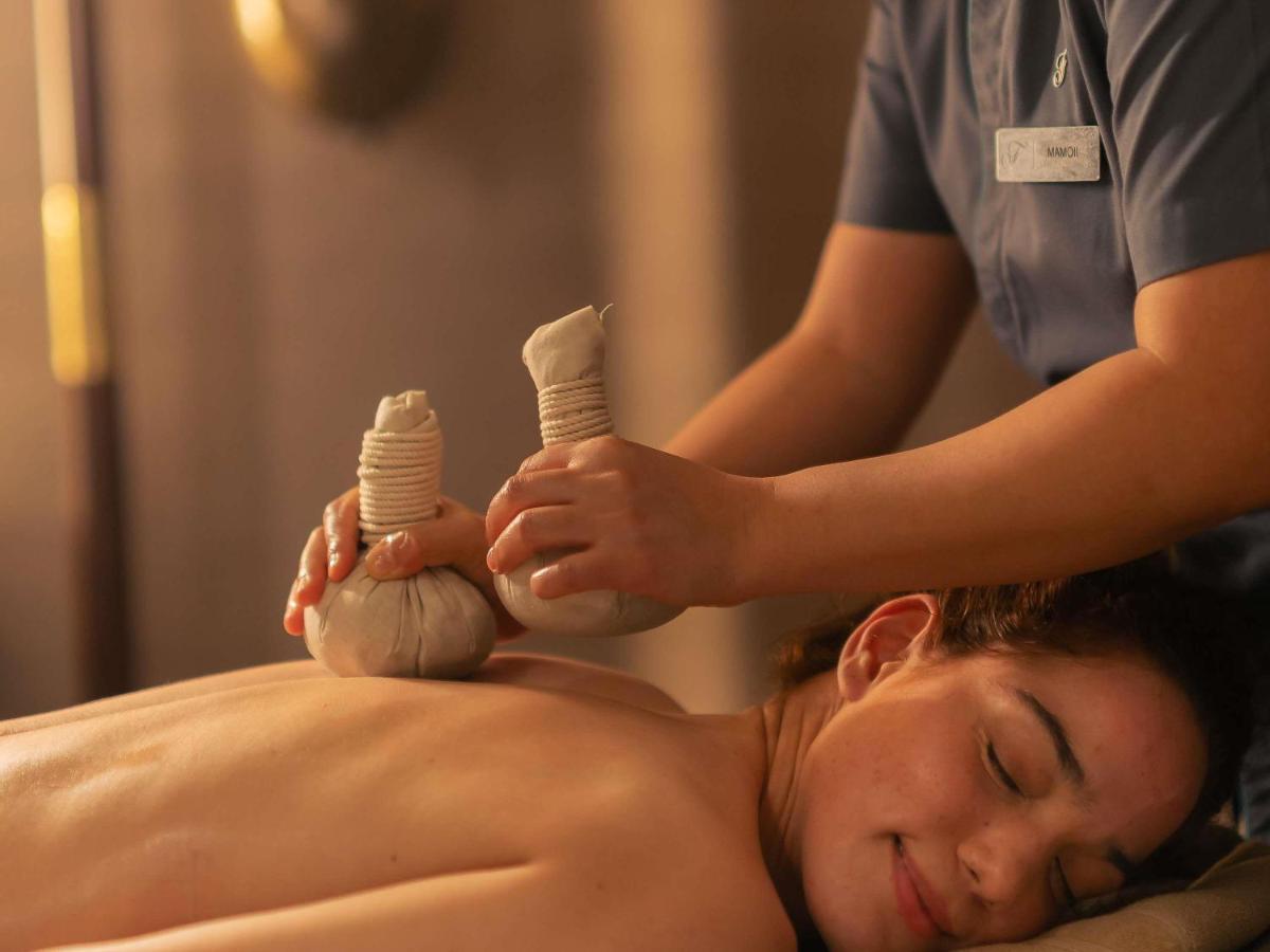 a woman getting a massage from a therapist at Fairmont Mumbai in Mumbai