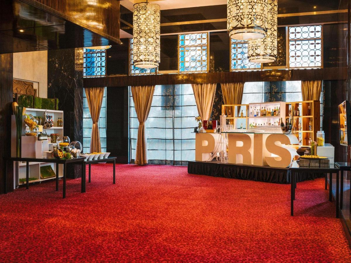 a room with a red carpet and a rbs booth at Sofitel Mumbai BKC in Mumbai