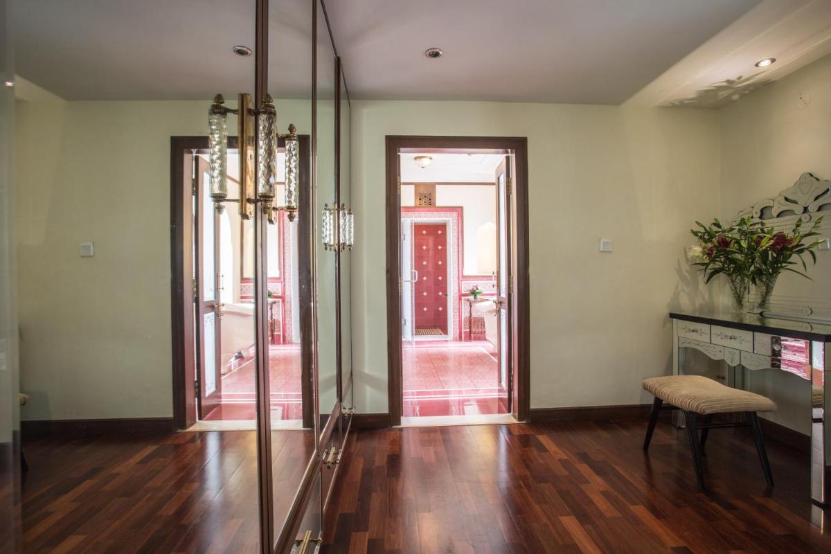a living room with a table and a chair and a door at Royal Heritage Haveli - By Leisure Hotels in Jaipur
