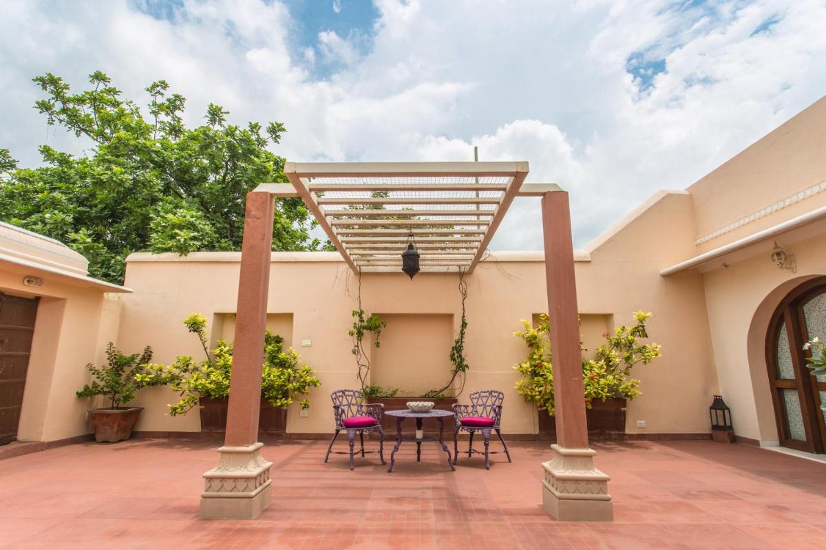 a patio with chairs and a table on a building at Royal Heritage Haveli - By Leisure Hotels in Jaipur
