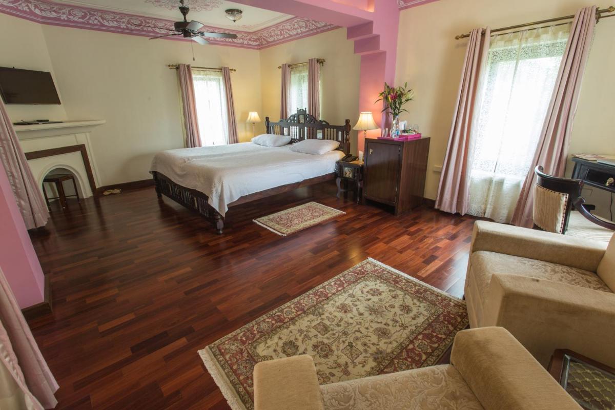 a bedroom with a bed and a living room at Royal Heritage Haveli - By Leisure Hotels in Jaipur