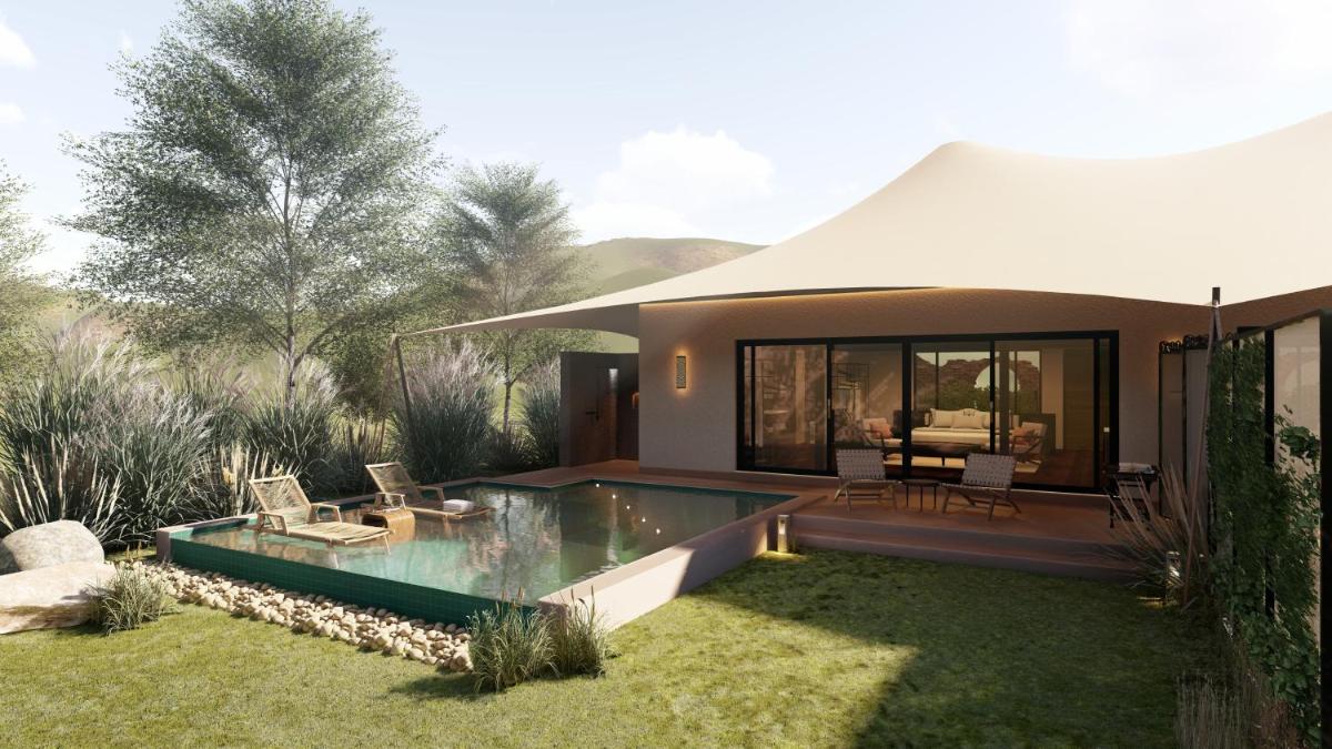 a house with a swimming pool in the yard at Alila Fort Bishangarh Jaipur - A Hyatt Brand in Jaipur a house with a swimming pool in the yard at Alila Fort Bishangarh Jaipur - A Hyatt Brand in Jaipur
