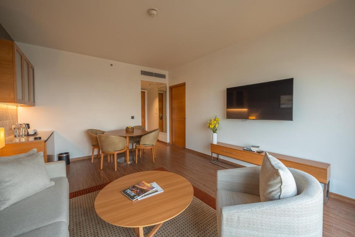 a living room with a couch and a table at Hyatt Place Gurgaon Udyog Vihar in Gurgaon