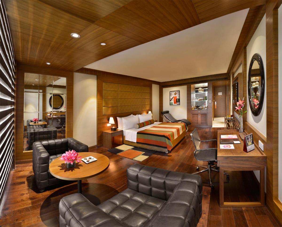 a hotel room with a bed and a couch at The Lalit Chandigarh in Chandīgarh