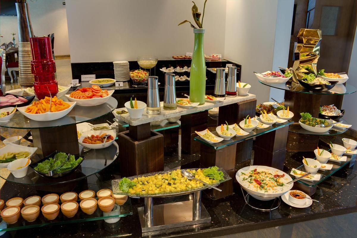 a buffet line with many different types of food at La Marvella, Bengaluru in Bengaluru