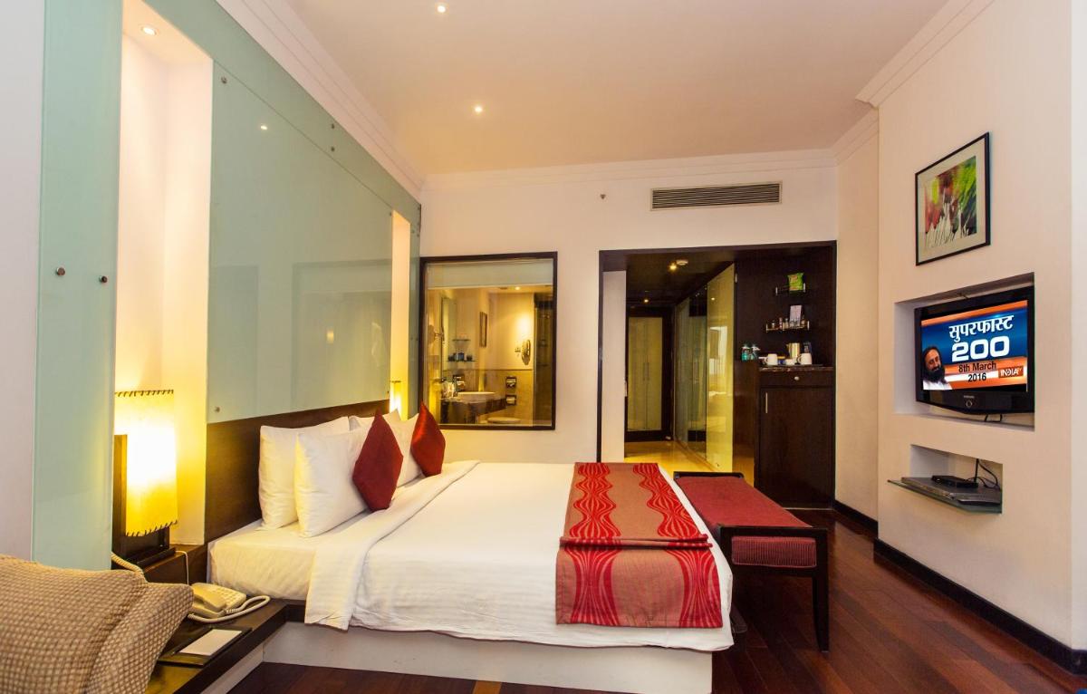 a hotel room with a bed and a television at The Chancery Pavilion in Bengaluru