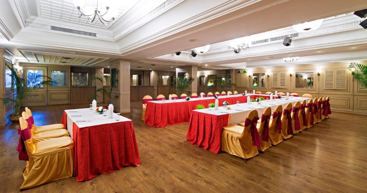 a large room with tables and chairs in it at Clarks Avadh in Lucknow