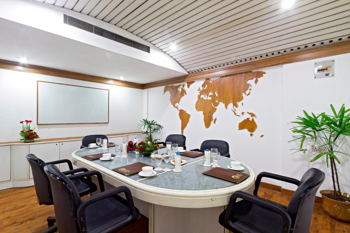 a meeting room with a large table and chairs at Clarks Avadh in Lucknow