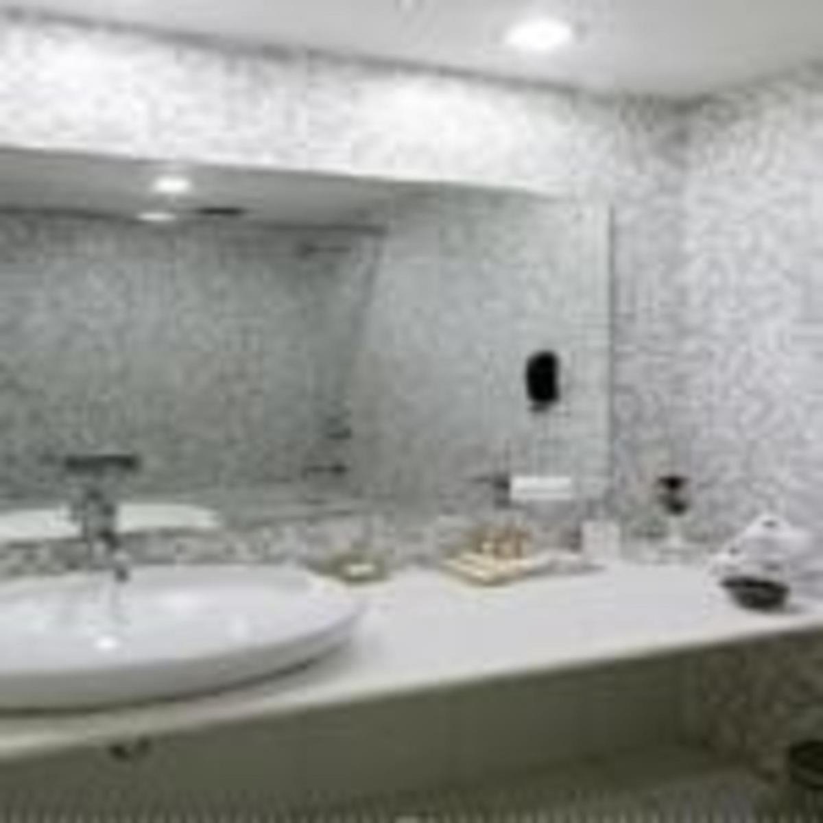 a bathroom with a sink and a mirror at Clarks Avadh in Lucknow