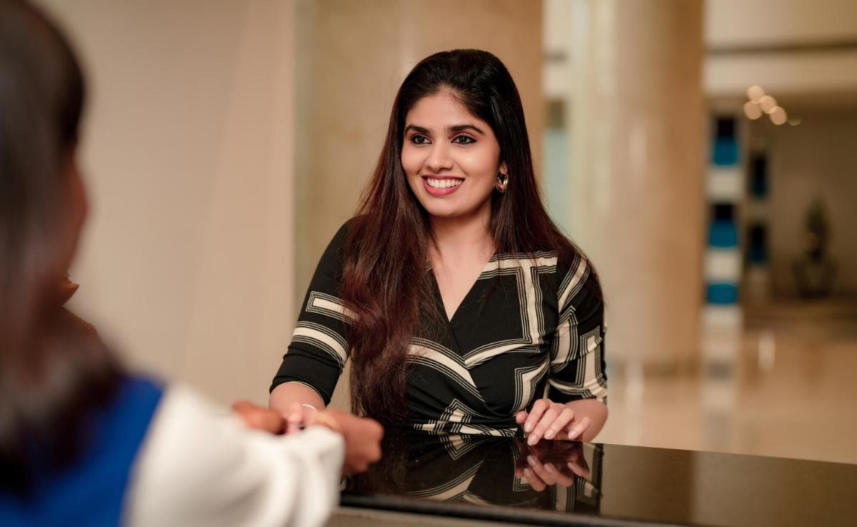 a woman standing in front of a mirror at Radisson Blu Kochi in Cochin