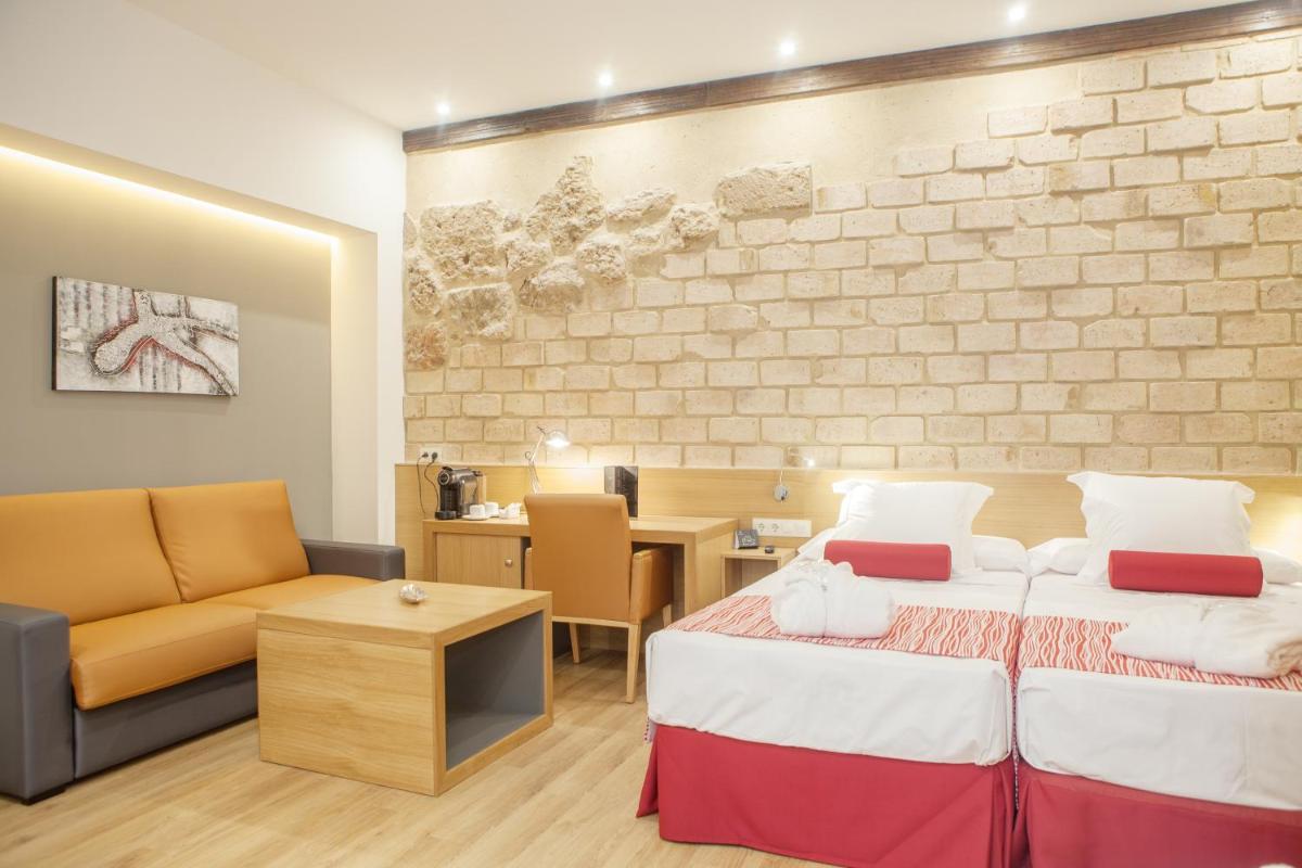 Cama o camas de una habitación en Soho Boutique Capuchinos & Spa