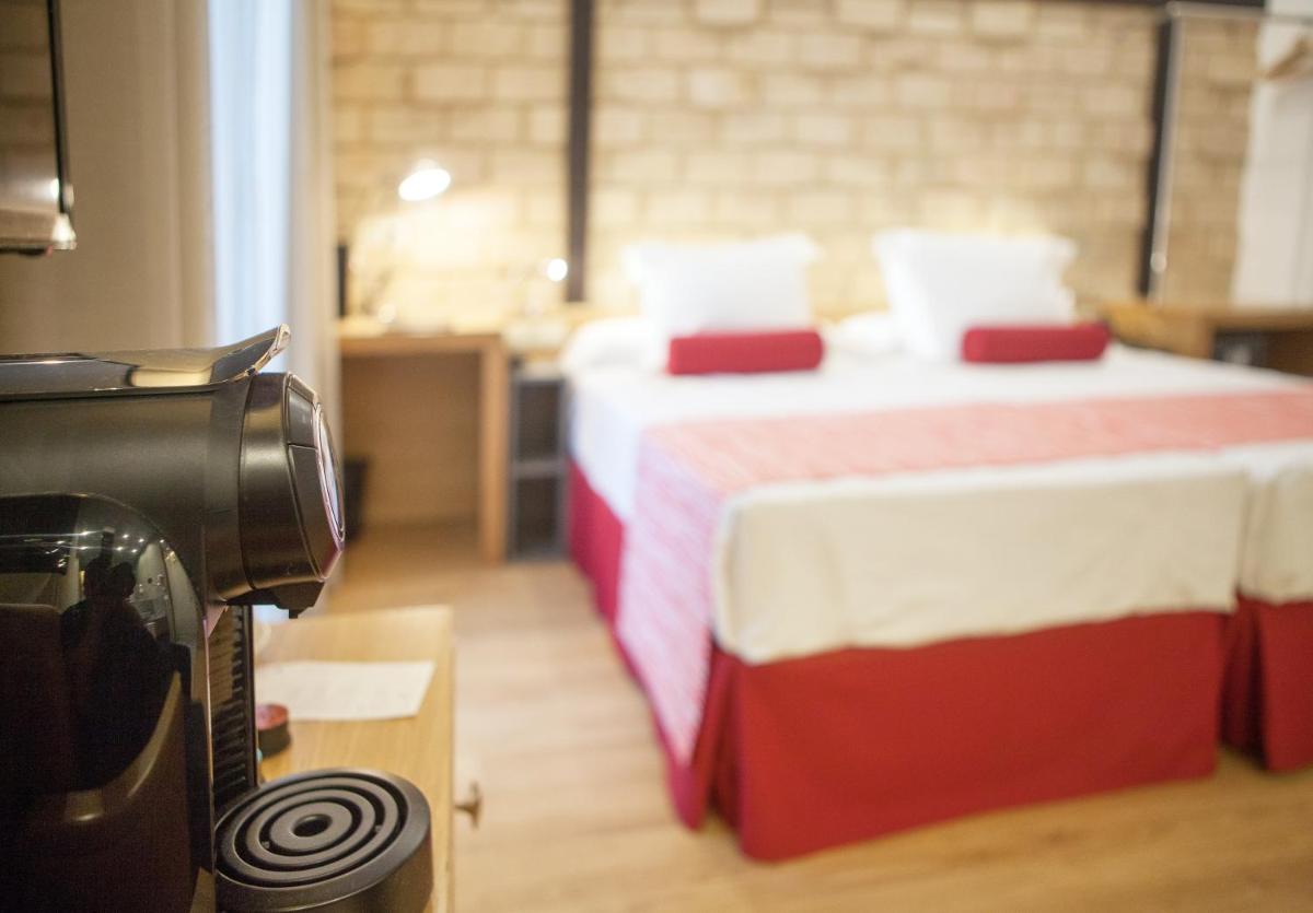 Cama o camas de una habitación en Soho Boutique Capuchinos & Spa