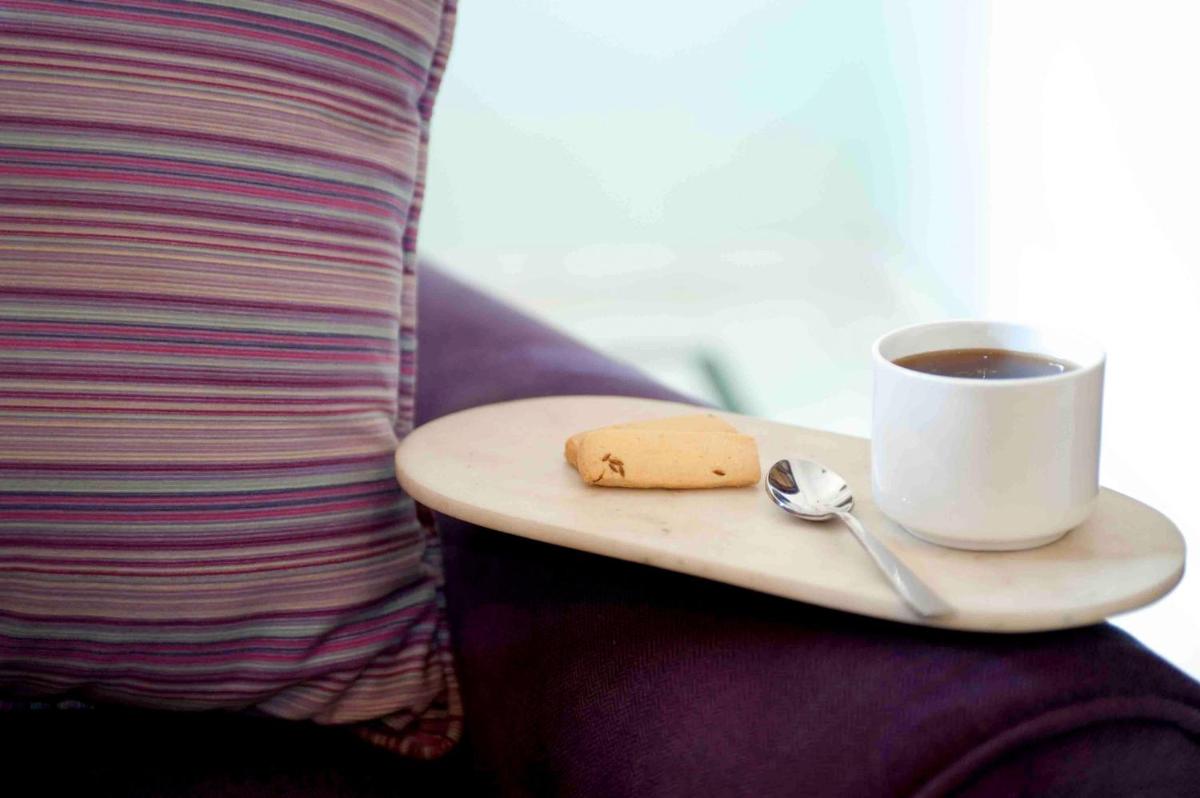 a tray with a cookie and a cup of coffee at Royal Heritage Haveli - By Leisure Hotels in Jaipur