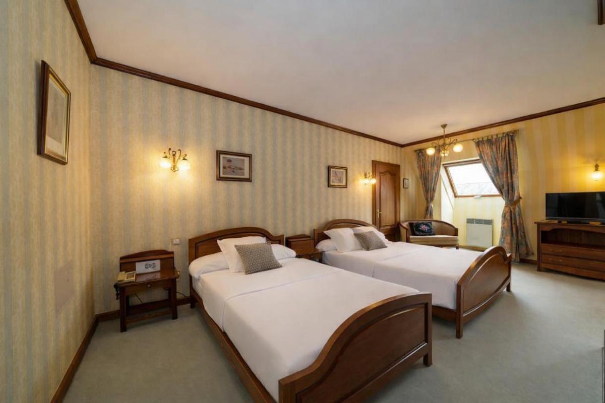 Un ou plusieurs lits dans un hébergement de l'établissement Hotel Munsch Restaurant & Wellness, Colmar Nord - Haut-Koenigsbourg