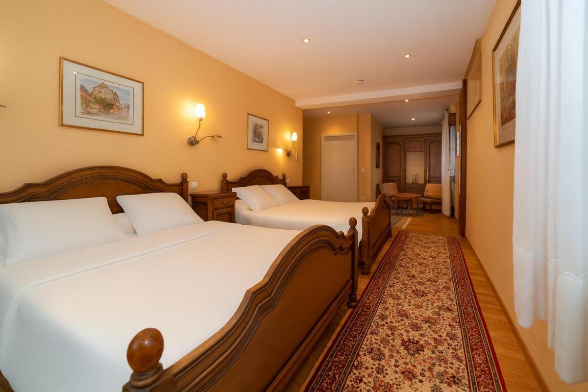 Un ou plusieurs lits dans un hébergement de l'établissement Hotel Munsch Restaurant & Wellness, Colmar Nord - Haut-Koenigsbourg