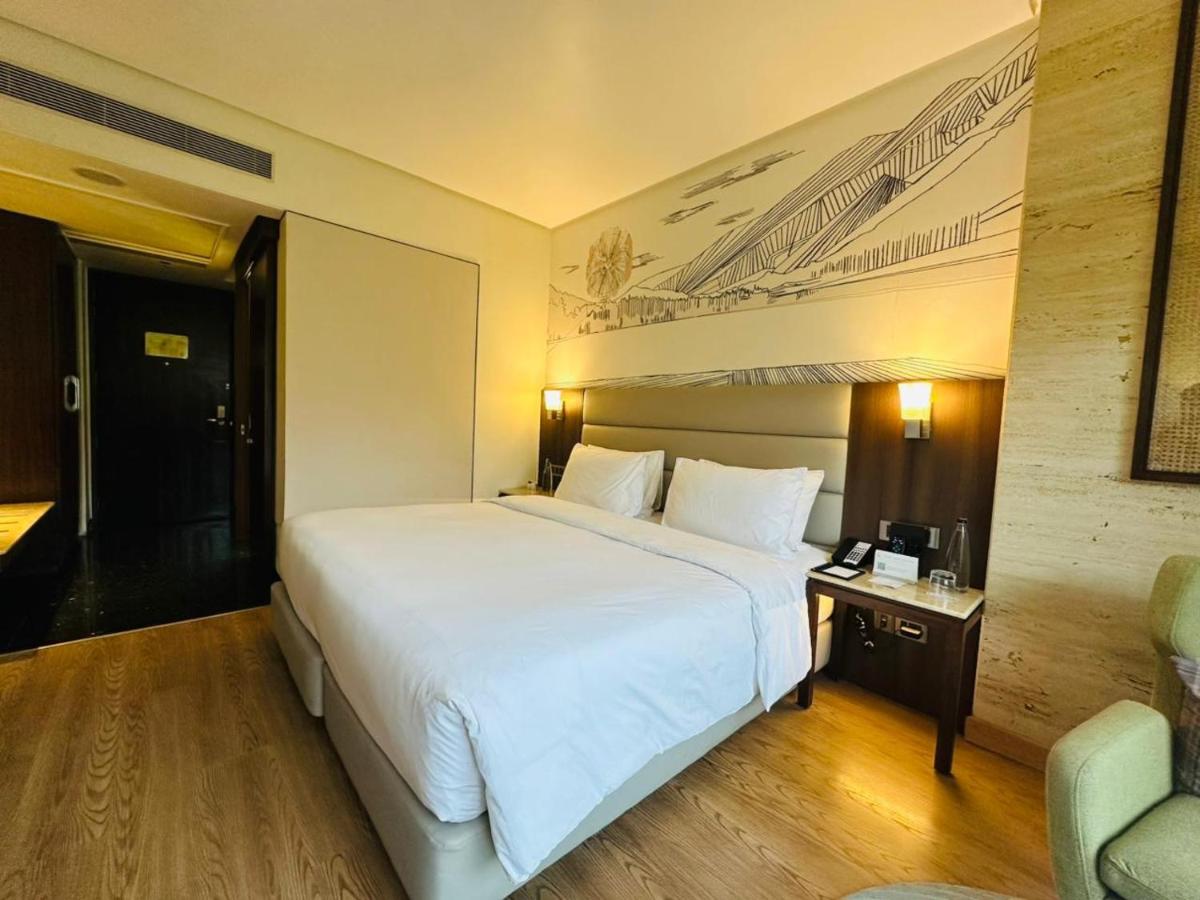 a large white bed in a hotel room at Hyatt Centric Rajpur Road Dehradun in Dehradun
