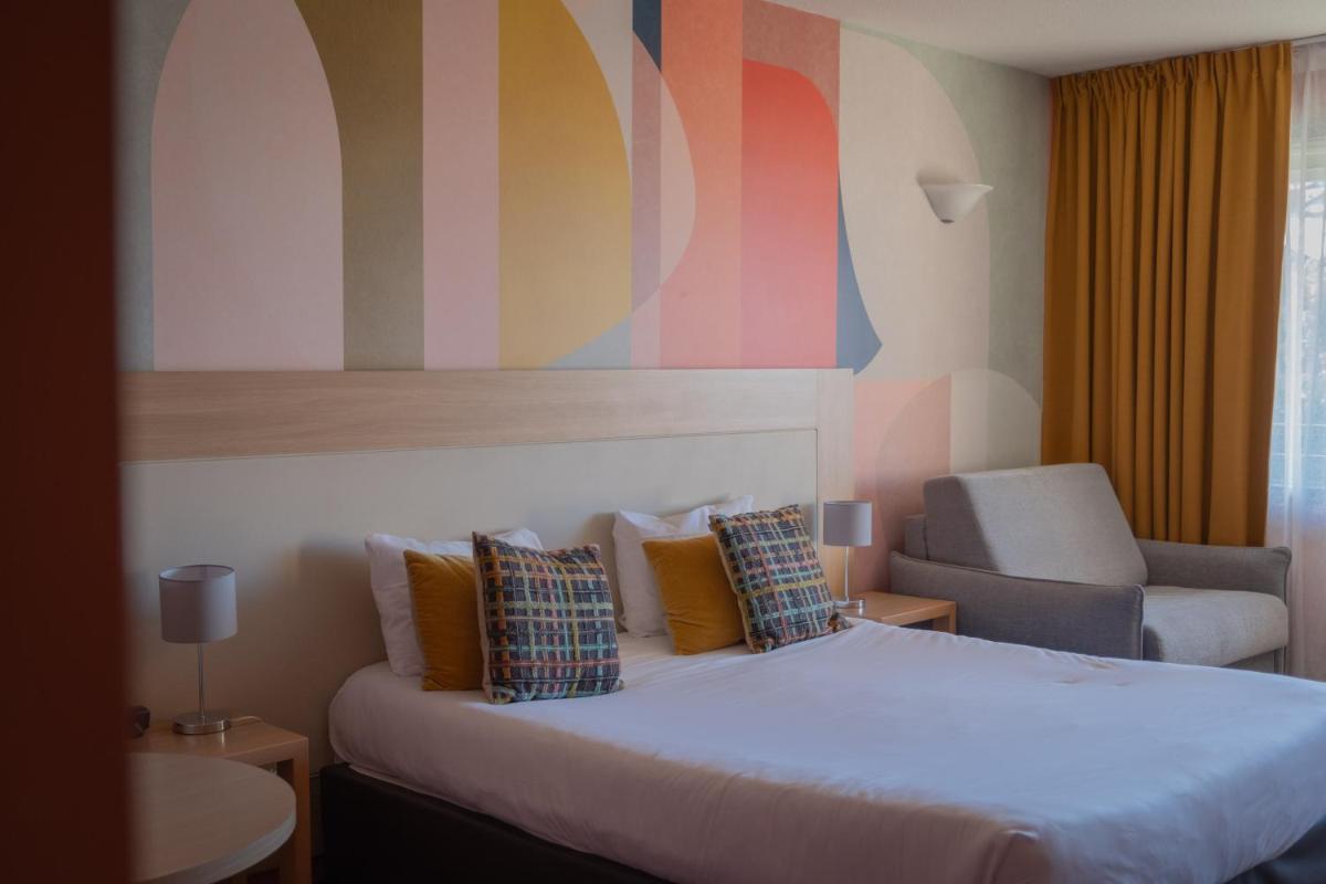 Un ou plusieurs lits dans un hébergement de l'établissement Hotel *** & Spa Vacances Bleues Villa Marlioz