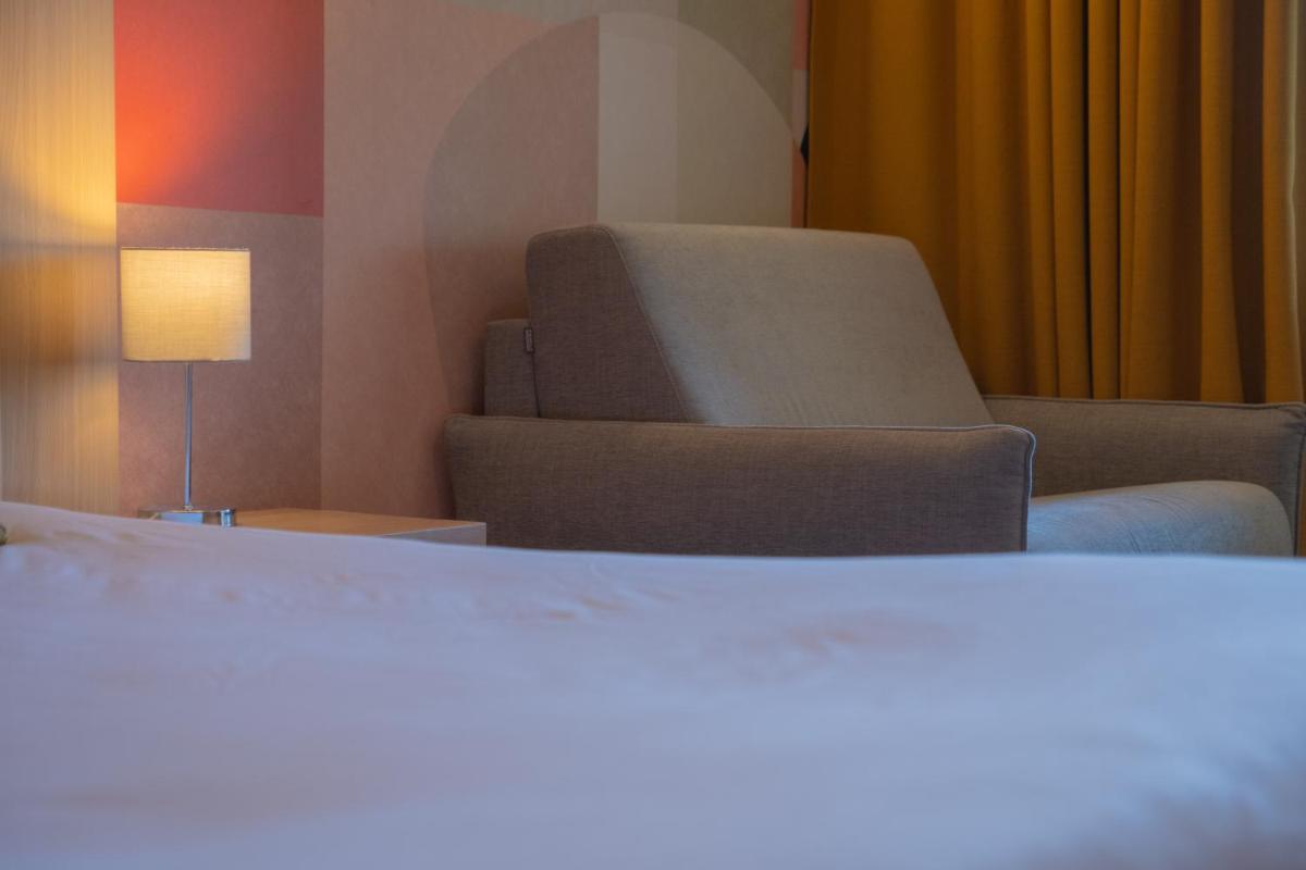 Un ou plusieurs lits dans un hébergement de l'établissement Hotel *** & Spa Vacances Bleues Villa Marlioz