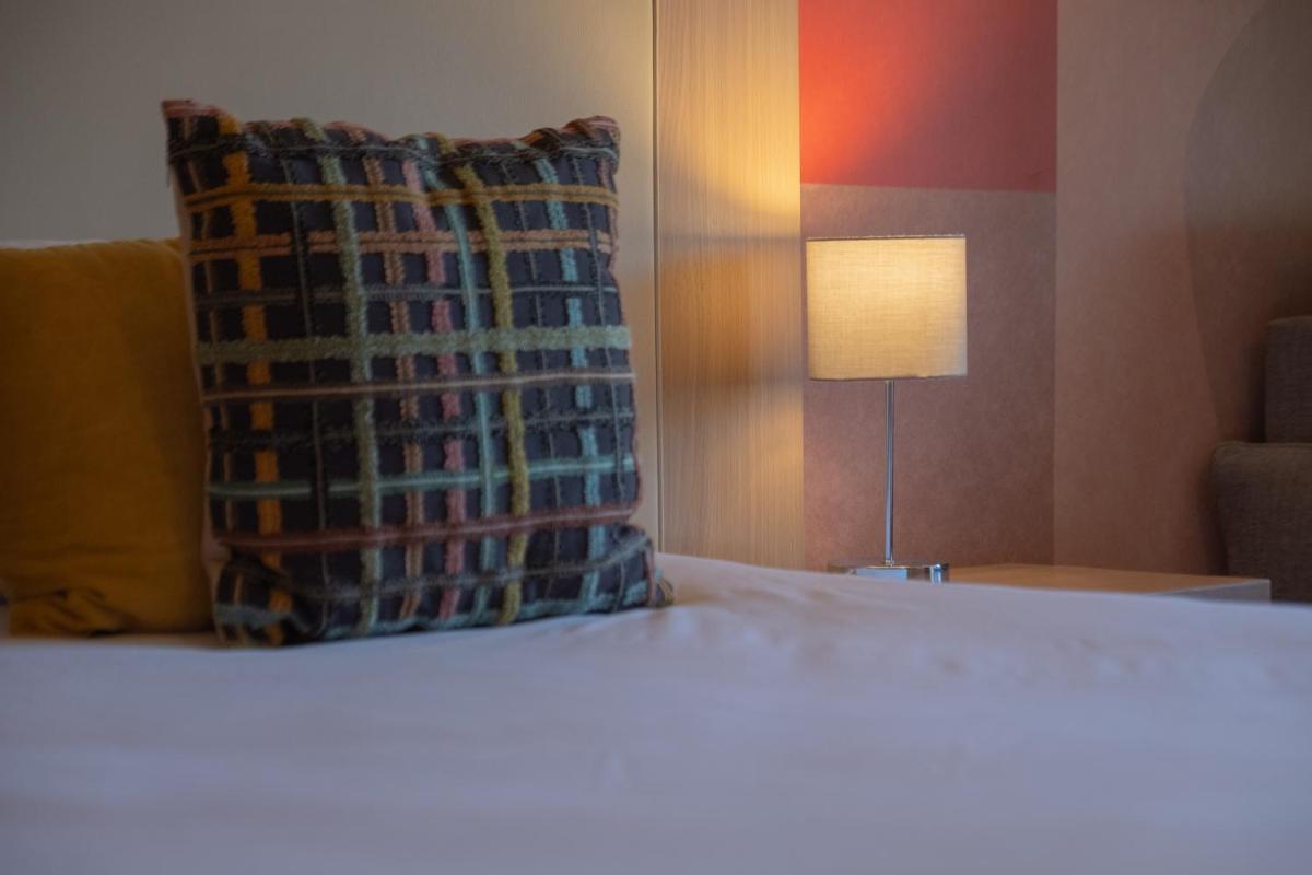 Un ou plusieurs lits dans un hébergement de l'établissement Hotel *** & Spa Vacances Bleues Villa Marlioz