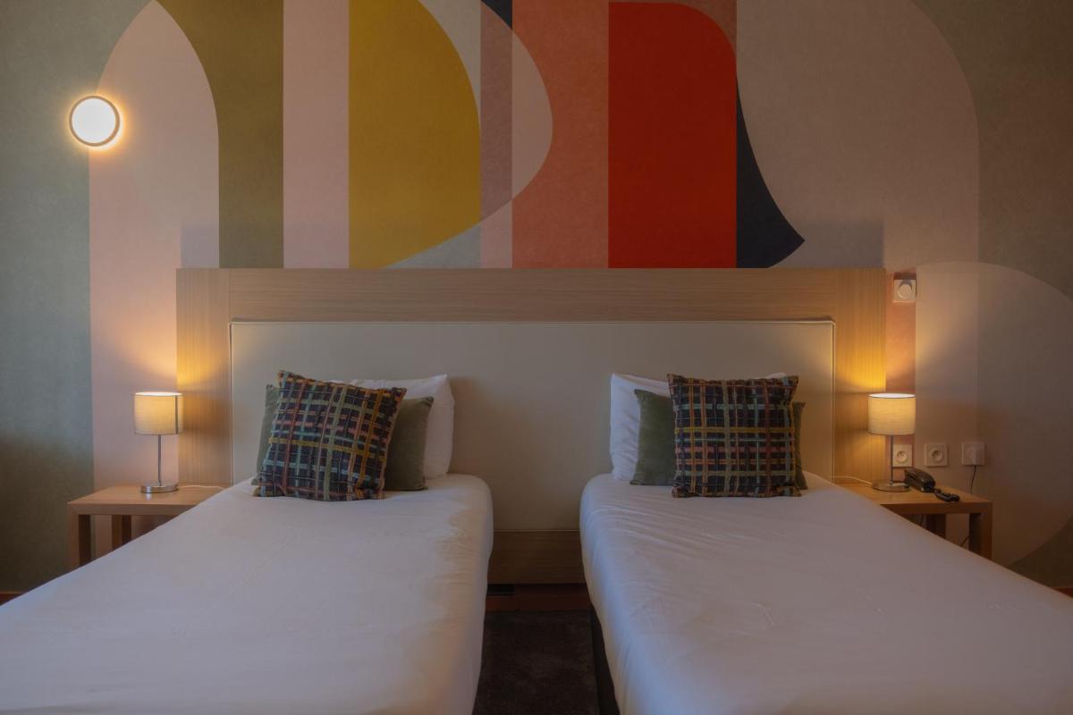Un ou plusieurs lits dans un hébergement de l'établissement Hotel *** & Spa Vacances Bleues Villa Marlioz