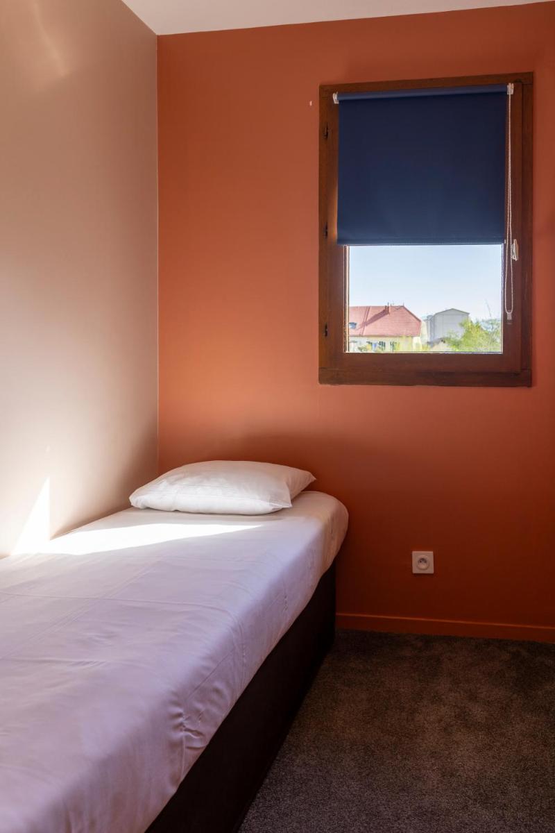 Un ou plusieurs lits dans un hébergement de l'établissement Hotel *** & Spa Vacances Bleues Villa Marlioz