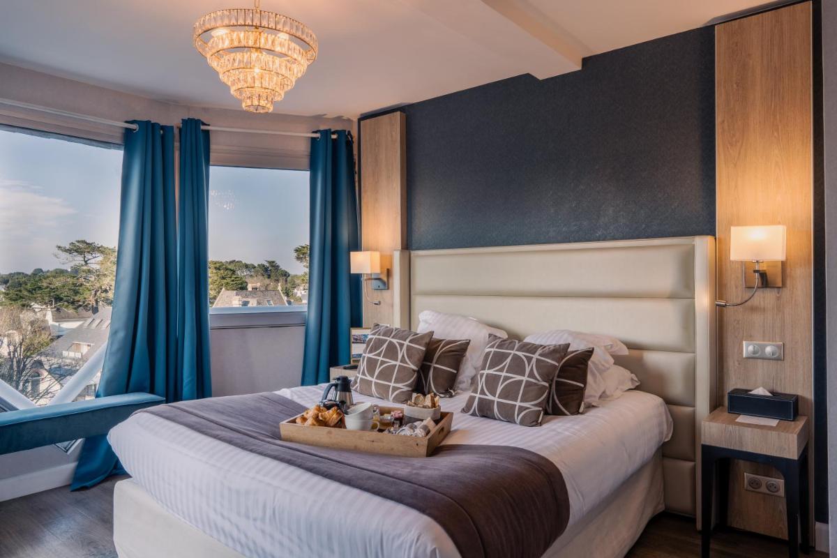 Un ou plusieurs lits dans un hébergement de l'établissement Le Diana Hôtel & Spa