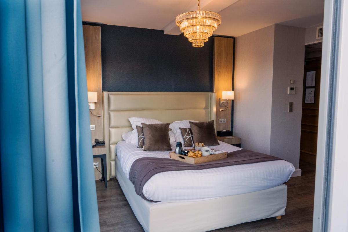 Un ou plusieurs lits dans un hébergement de l'établissement Le Diana Hôtel & Spa