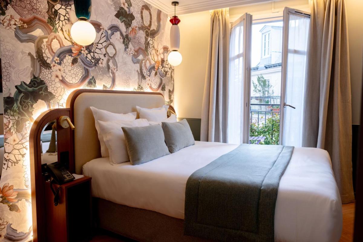 Un ou plusieurs lits dans un hébergement de l'établissement Grand Hotel Saint Michel
