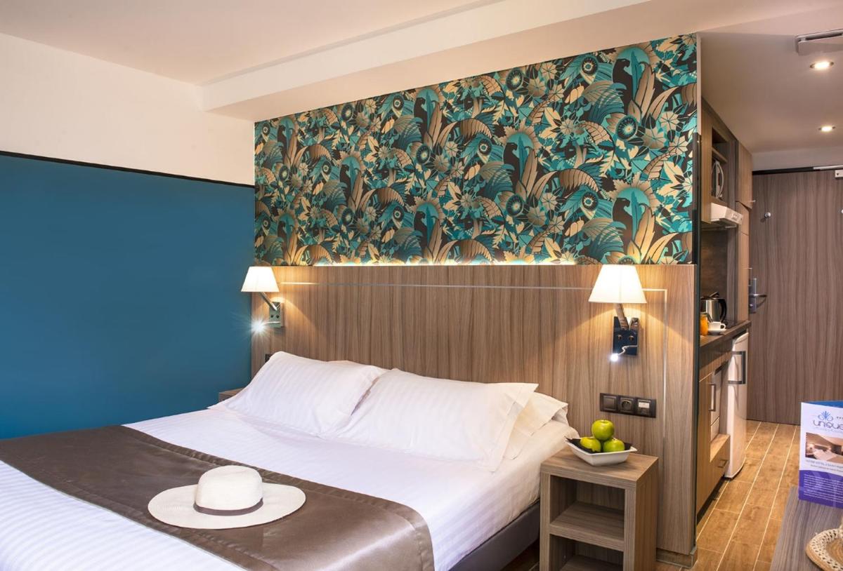 Un ou plusieurs lits dans un hébergement de l'établissement Unique Hôtel Résidence & Spa