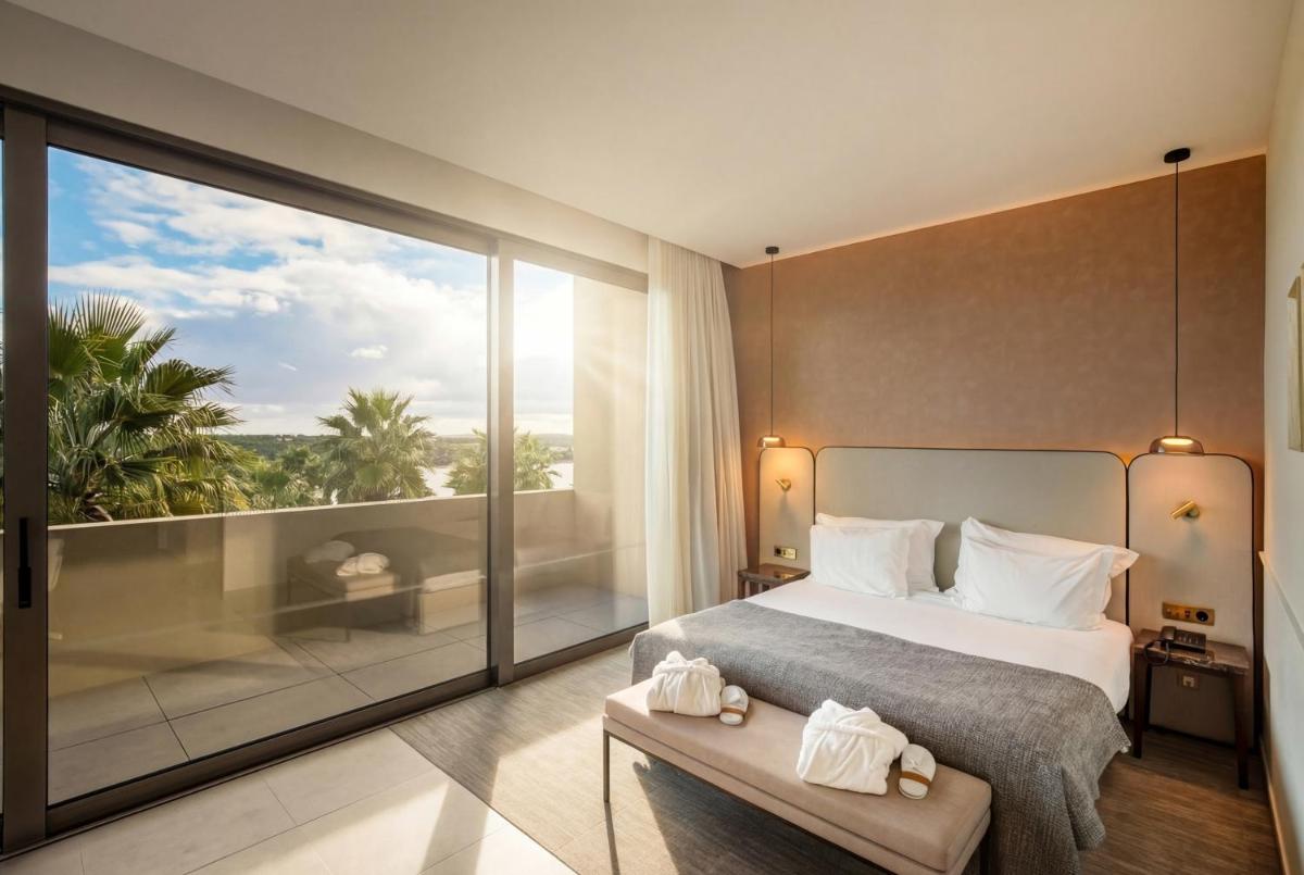Uma cama ou camas num quarto em AP Lago Montargil - Conference & SPA