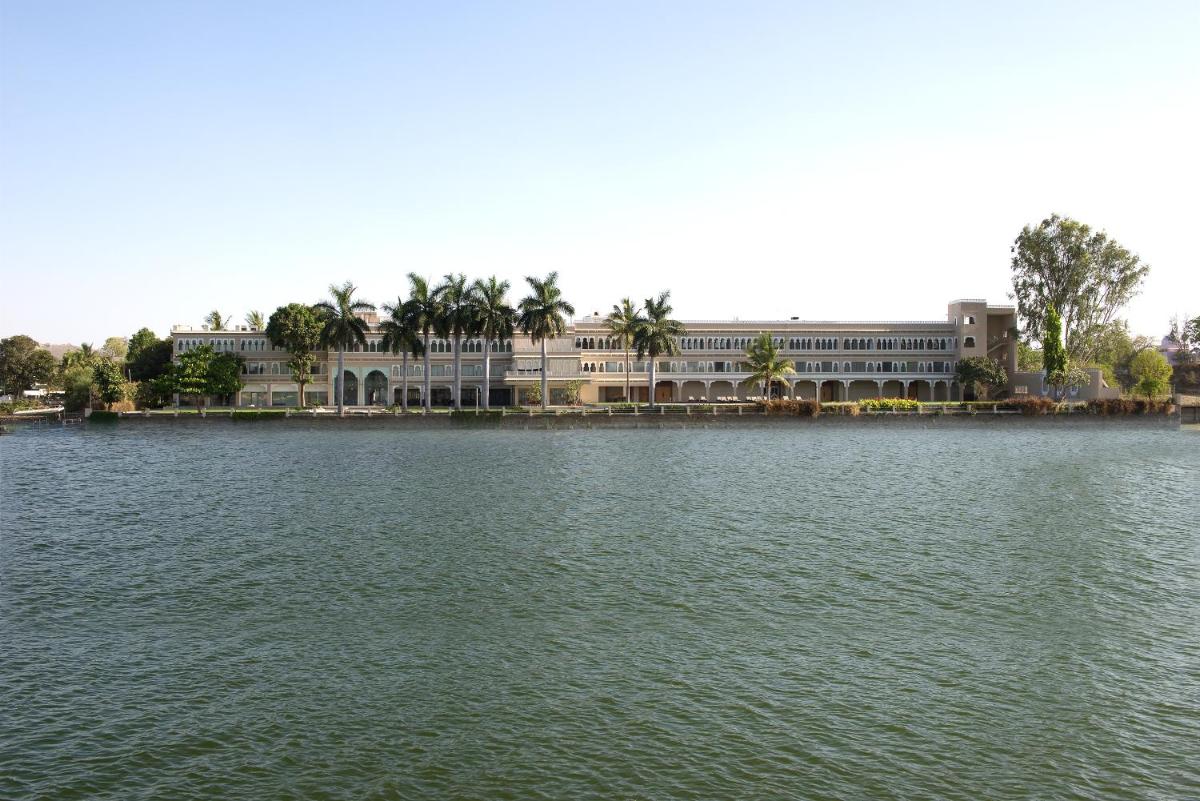 a large building in front of a large body of water at Hotel Lakend in Udaipur